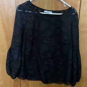 Black sheer top with flower detailing.
